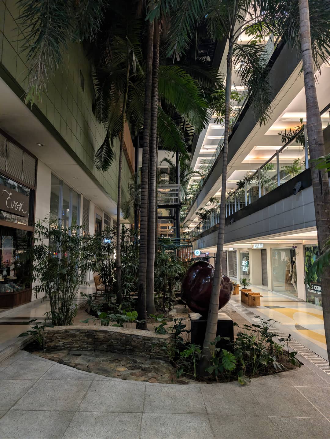 The floors of the shopping centre with palms between them.