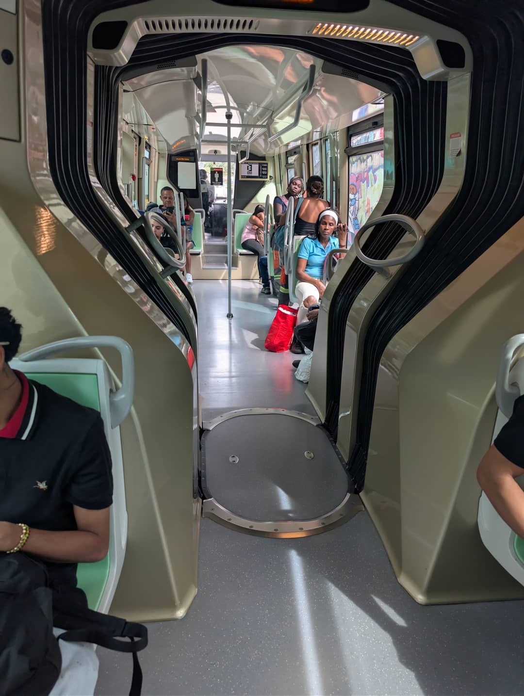 Inside the tram. Calm, air conditioning, and people riding home with the shopping.