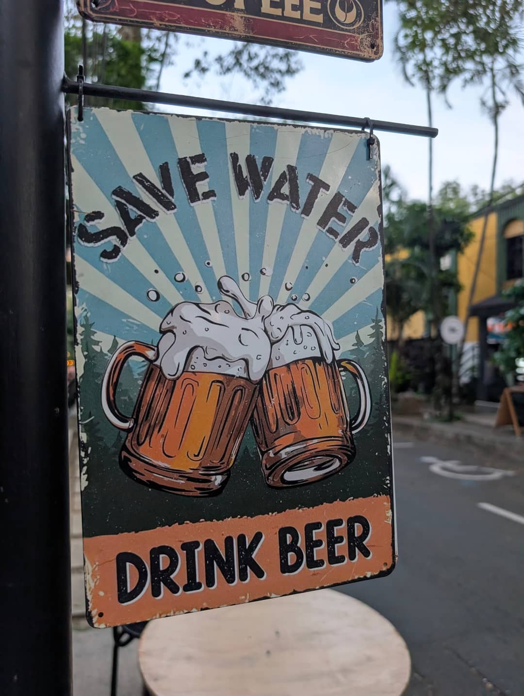 A sign over a bar: save water, drink beer.