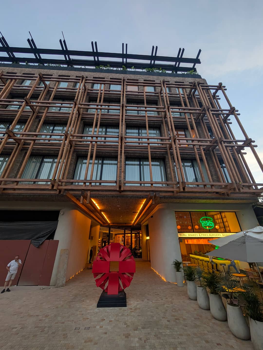 A new building with a timber lattice across its whole face.