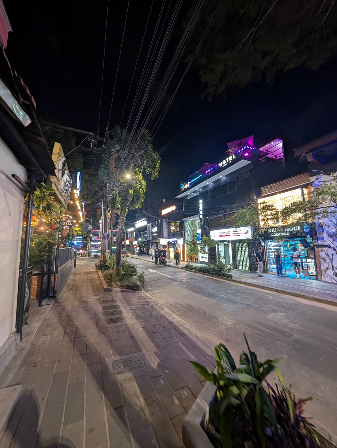 The pavement along the bars.