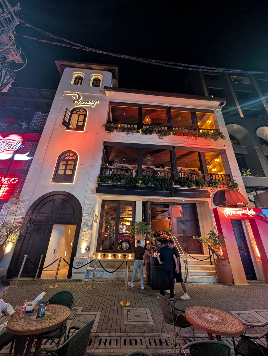 The white building with a tower: the restaurant and rooftop of the singer Karol G on Carrera 35. The Bichota neon sits next door.