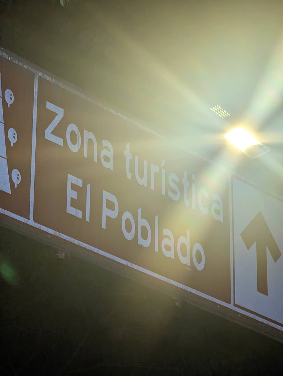 A road sign: El Poblado tourist zone.