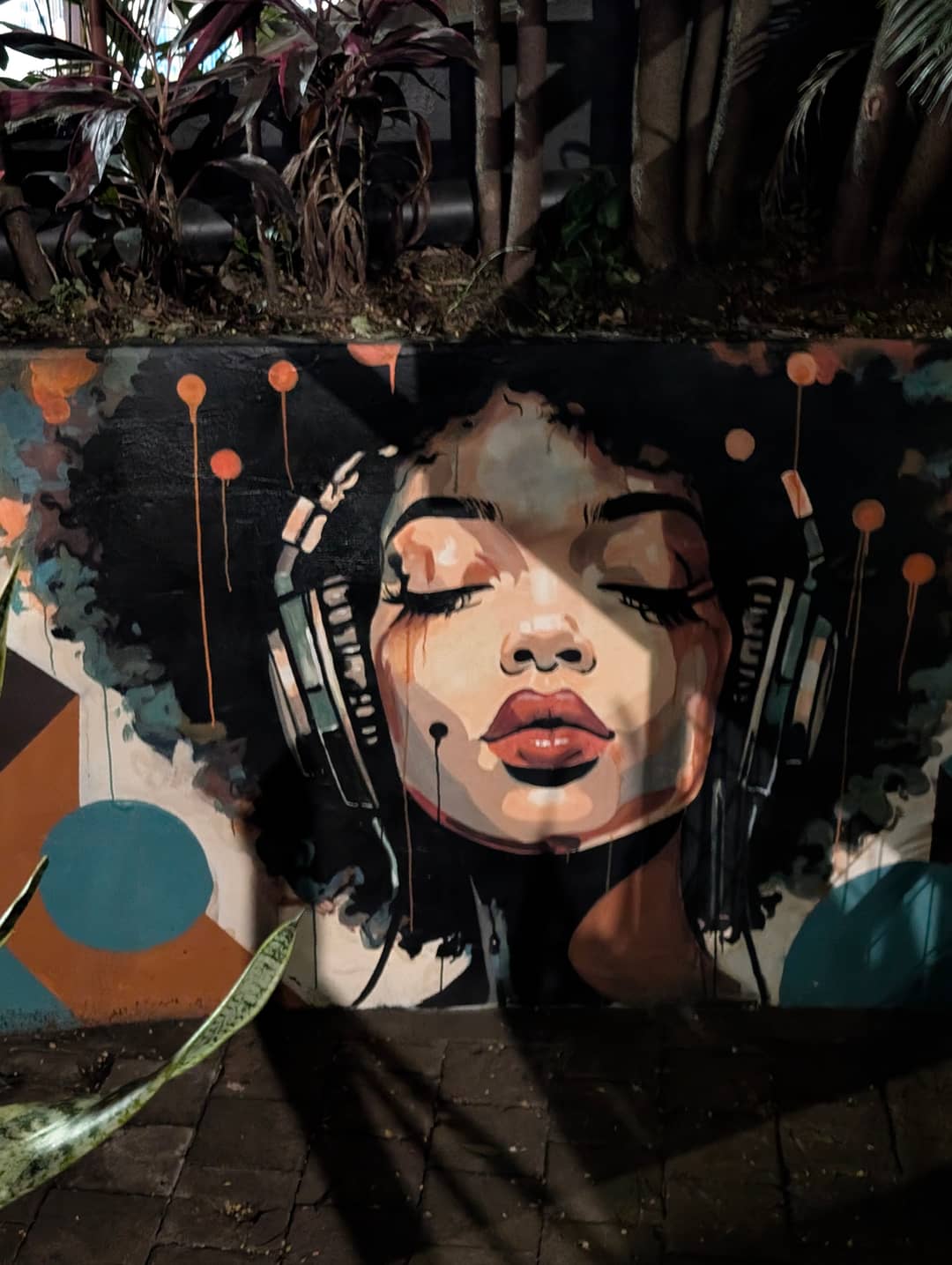A mural on a wall by the street.