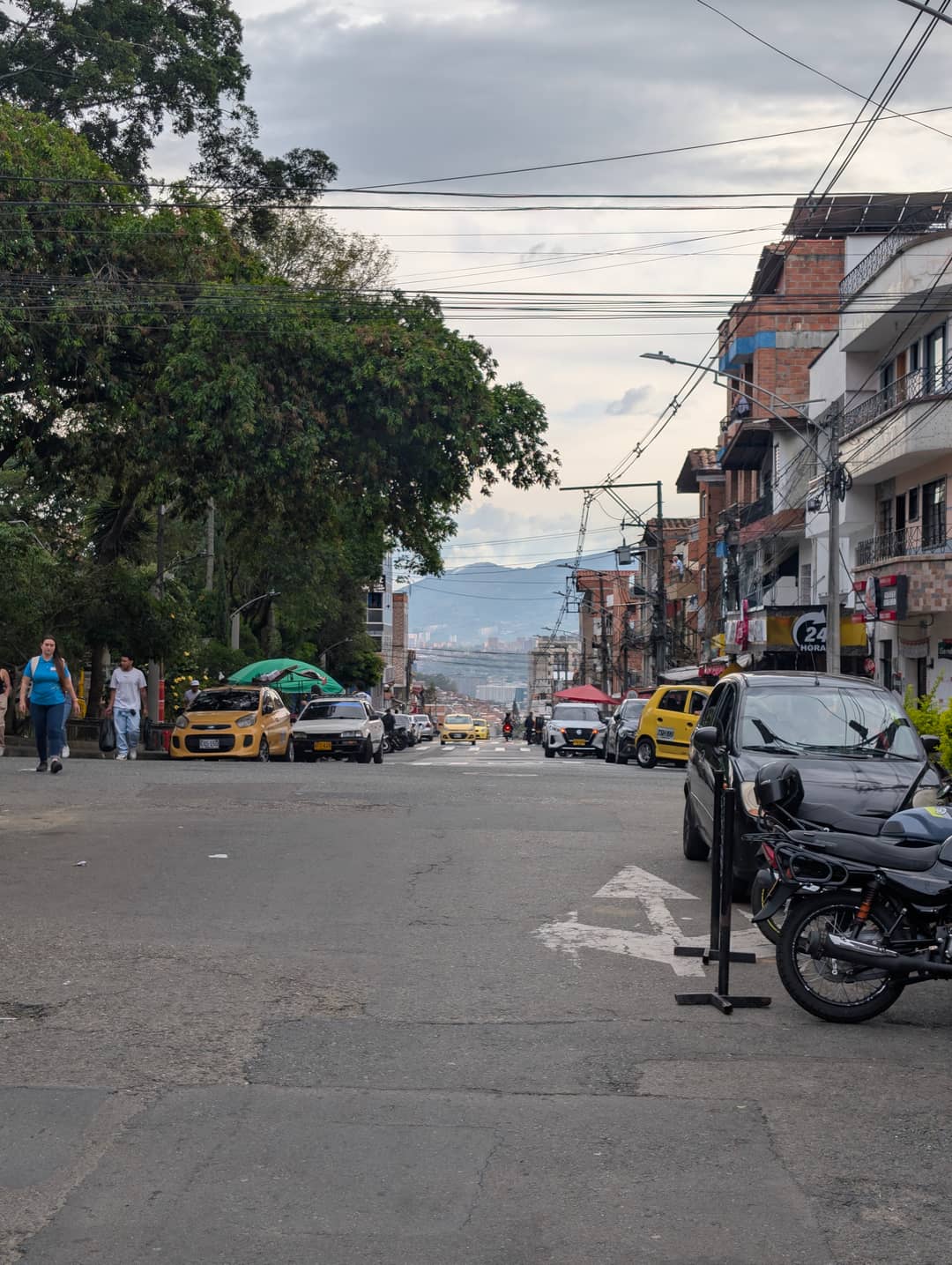 A street in Villa Hermosa dropping towards the centre, yellow taxis.