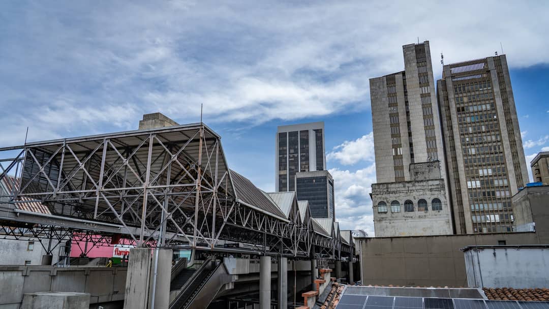 The steel structure of a metro station and the towers around it.