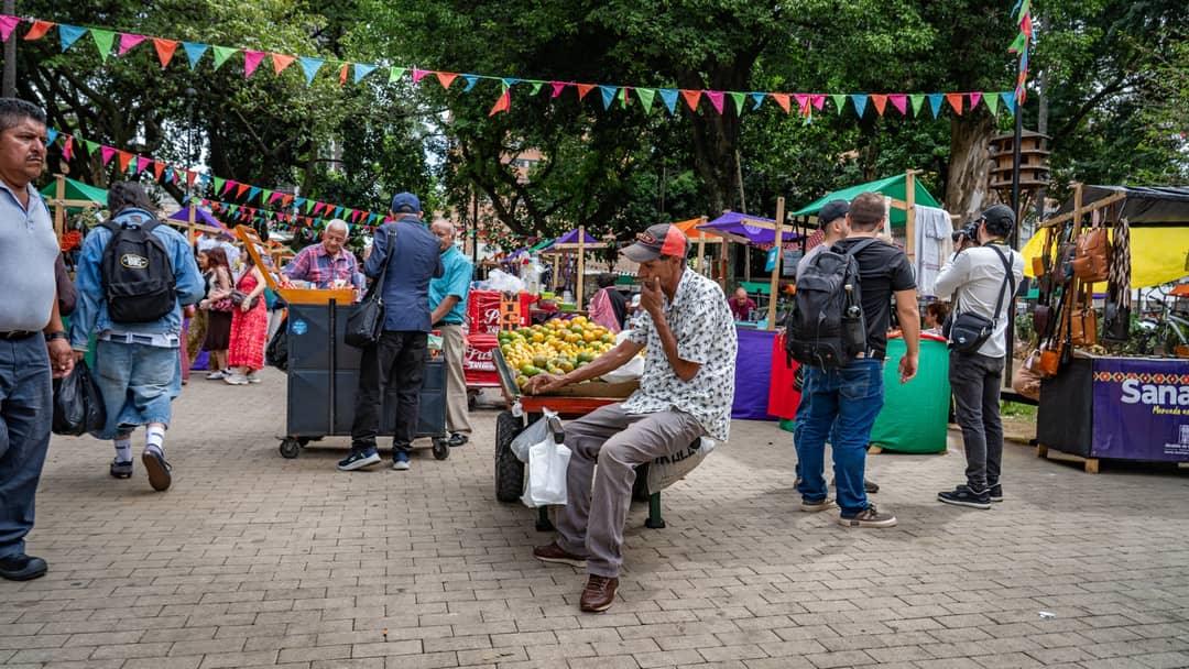 A fruit seller in the market crowd.