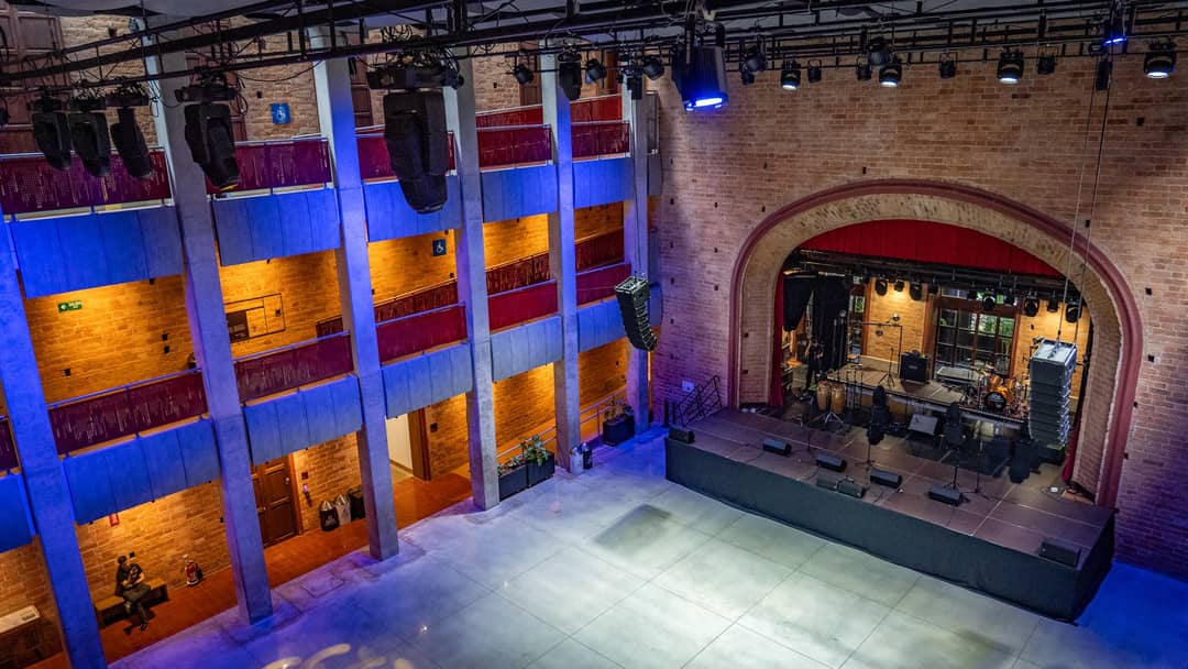 The concert hall in the basement. A band was rehearsing for the evening.
