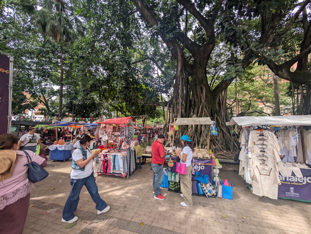 Stalls in the shade of the trees by the park.